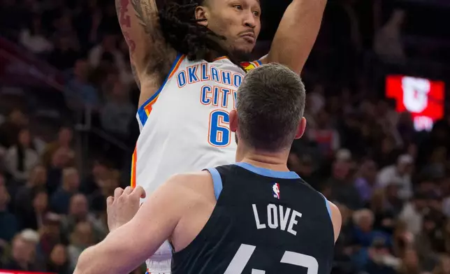Oklahoma City Thunder forward Jaylin Williams (6) looks to pass the ball as Utah Jazz forward/center Kevin Love (42) defends during the first half of an NBA basketball game Sunday, Dec. 7, 2025, in Salt Lake City. (AP Photo/Bethany Baker)