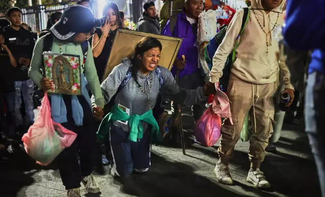 Pilgrims arrive at Our Lady of Guadalupe Basilica in Mexico City, Thursday, Dec. 11, 2025, the day before her feast day. (AP Photo/Claudia Rosel)