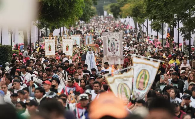 Pilgrims arrive at Our Lady of Guadalupe Basilica in Mexico City, Thursday, Dec. 11, 2025, the day before her feast day. (AP Photo/Claudia Rosel)