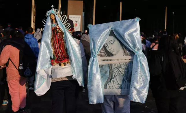 People carry images of the Virgin of Guadalupe to the Basilica of Our Lady of Guadalupe in Mexico City, on her feast day, Friday, Dec. 12, 2025. (AP Photo/Claudia Rosel)