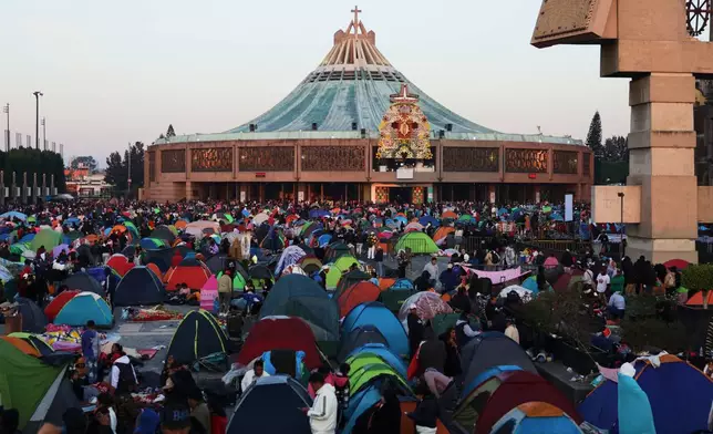 Pilgrims gather outside the Basilica of Our Lady of Guadalupe in Mexico City, on her feast day, Friday, Dec. 12, 2025. (AP Photo/Claudia Rosel)