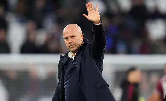 Liverpool's manager Arne Slot waves to fans after the English Premier League soccer match between West Ham United and Liverpool, in London, Sunday, Nov. 30, 2025. (AP Photo/Kirsty Wigglesworth)