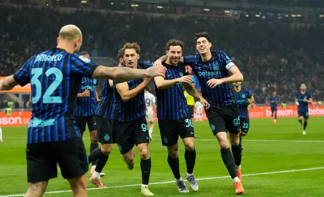 Inter Milan's Carlos Augusto celebrates with his teammates after scoring his side's fourth goal during a Serie A soccer match between Inter and Como, in Milan, Italy, Saturday, Dec. 6, 2025. (AP Photo/Luca Bruno)