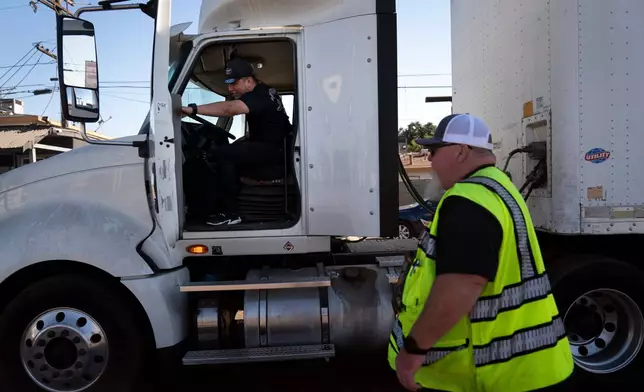 FILE - A student driver gets on a truck as the instructor watches in Calif., Nov. 15, 2021. (AP Photo/Jae C. Hong, File)