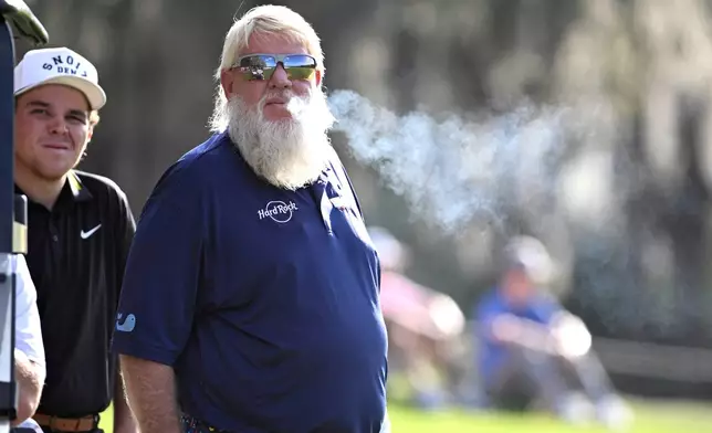 John Daly waits to hit from the 14th fairway as his son John Daly II looks on during the final round of the PNC Championship golf tournament, Sunday, Dec. 21, 2025, in Orlando, Fla. (AP Photo/Phelan M. Ebenhack)