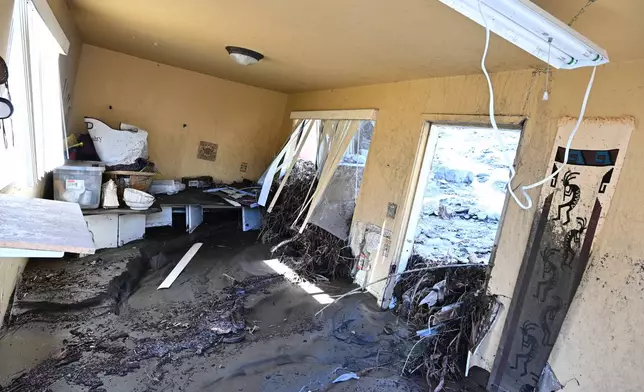 Mud covers the inside of a property after a series of storms on Thursday, Dec. 25, 2025, in Wrightwood, Calif. (AP Photo/William Liang)