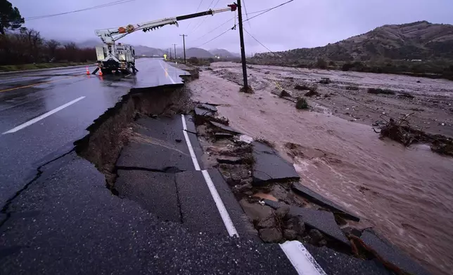 Part of California State Route 138 washes away from flooding Wednesday, Dec. 24, 2025, outside of Wrightwood, Calif. (AP Photo/Wally Skalij)