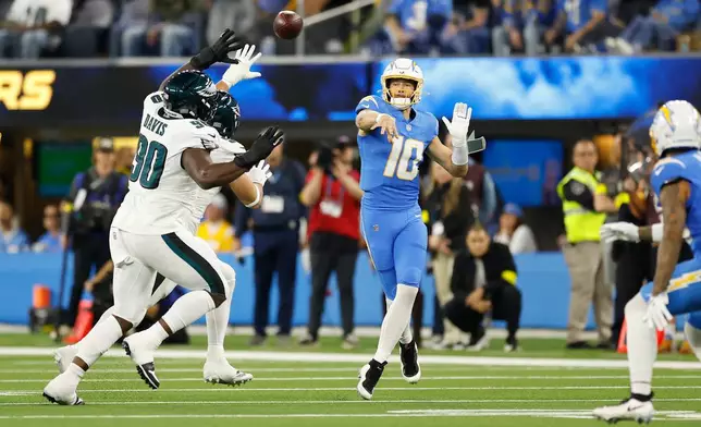 Los Angeles Chargers quarterback Justin Herbert (10) throws a pass during the first half of an NFL football game against the Philadelphia Eagles, Monday, Dec. 8, 2025, in Inglewood, Calif. (AP Photo/Caroline Brehman)