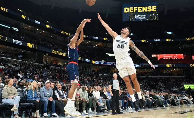 Los Angeles Clippers guard Cam Christie, left, shoots as Memphis Grizzlies guard John Konchar (46) defends during the first half of an NBA basketball game, Friday, Dec. 5, 2025, in Memphis, Tenn. (AP Photo/John Amis)