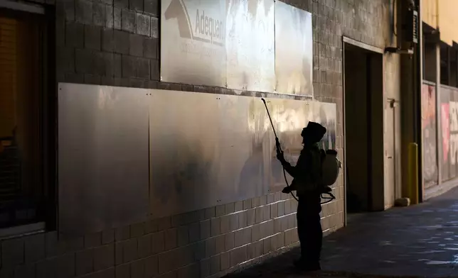 A worker disinfects walls at the South Point hotel-casino in Las Vegas Tuesday, Dec. 9, 2025, in Las Vegas. (AP Photo/John Locher)