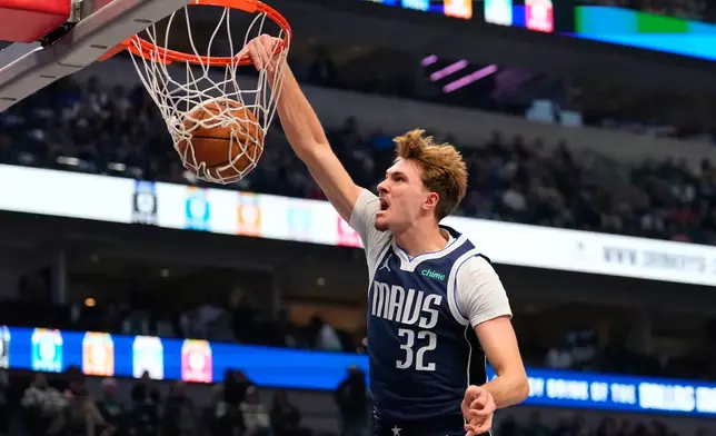 Dallas Mavericks forward Cooper Flagg (32) dunks in the first half of an NBA basketball game against the Detroit Pistons in Dallas, Thursday, Dec. 18, 2025. (AP Photo/Tony Gutierrez)