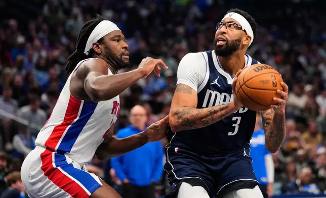 Dallas Mavericks forward Anthony Davis (3) works for a shot attempt against Detroit Pistons forward Isaiah Stewart, left, in the first half of an NBA basketball game in Dallas, Thursday, Dec. 18, 2025. (AP Photo/Tony Gutierrez)