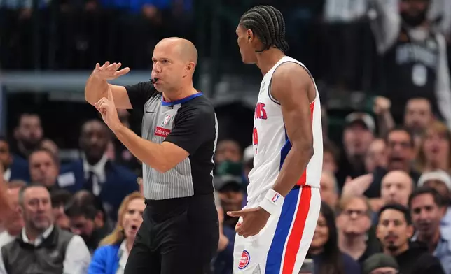 Referee John Goble (10) issues a technical foul to Detroit Pistons' Ausar Thompson, right, in the first half of an NBA basketball game against the Dallas Mavericks in Dallas, Thursday, Dec. 18, 2025. (AP Photo/Tony Gutierrez)
