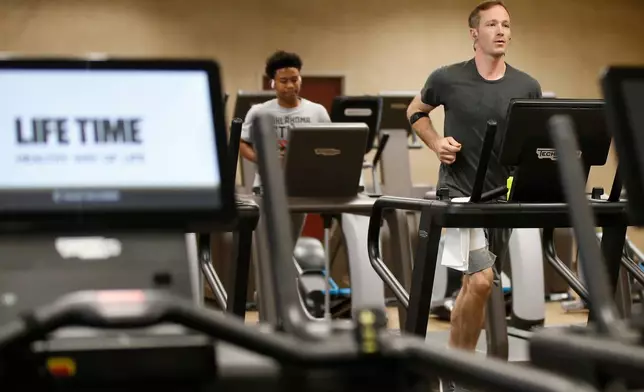 FILE - People run on treadmills at Life Time Athletic May 8, 2020, in Oklahoma City. (AP Photo/Sue Ogrocki, File)