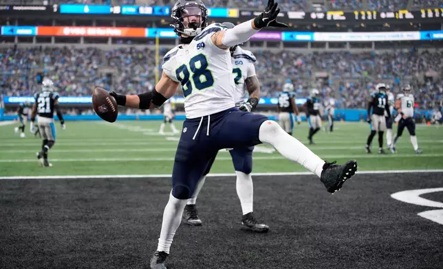 Seattle Seahawks tight end AJ Barner celebrates after scoring against the Carolina Panthers during the second half of an NFL football game, Sunday, Dec. 28, 2025, in Charlotte, N.C. (AP Photo/Jacob Kupferman)