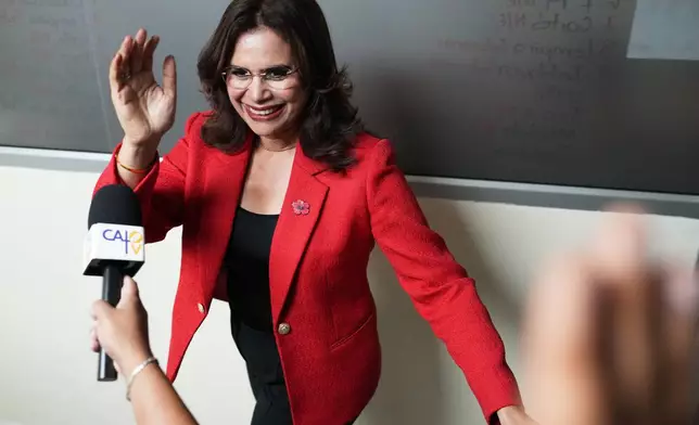 Ruling party presidential candidate Rixi Moncada arrives to the party's headquarters before speaking to supporters in Tegucigalpa, Honduras, Monday, Dec. 1, 2025. (AP Photo/Moises Castillo)