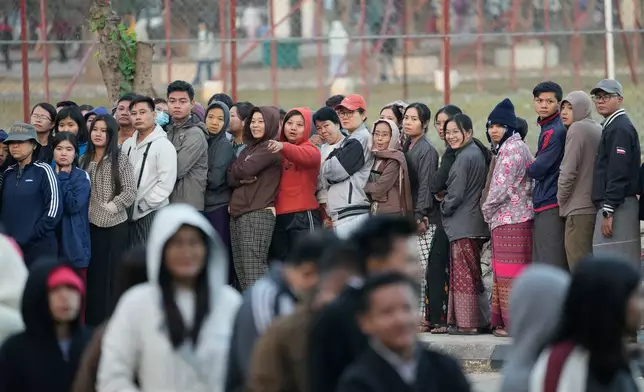 Voters line up to cast their ballots at a polling station in Naypyitaw, Myanmar, Sunday, Dec. 28, 2025. (AP Photo/Aung Shine Oo)