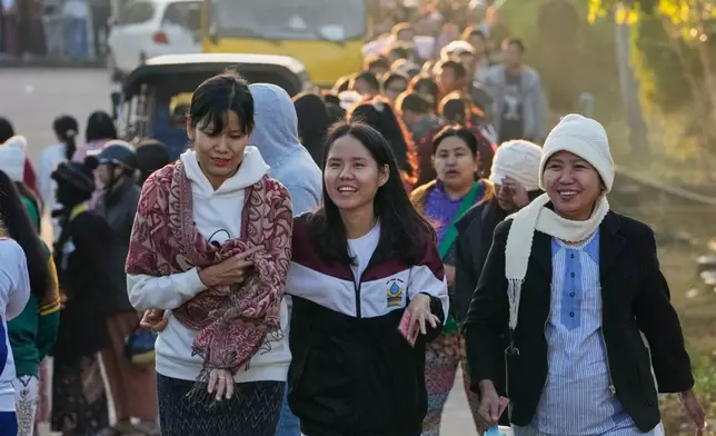 Voters leave after voting at a polling station in Naypyitaw, Myanmar, Sunday, Dec. 28, 2025. (AP Photo/Aung Shine Oo)