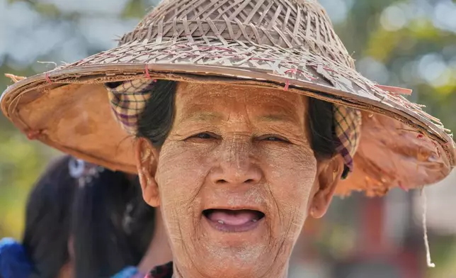 A woman lines up to cast her vote at a polling station in Naypyitaw, Myanmar, Sunday, Dec. 28, 2025. (AP Photo/Aung Shine Oo)