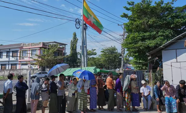 Voters line up to cast their ballots at a polling station in Naypyitaw, Myanmar, Sunday, Dec. 28, 2025. (AP Photo/Aung Shine Oo)