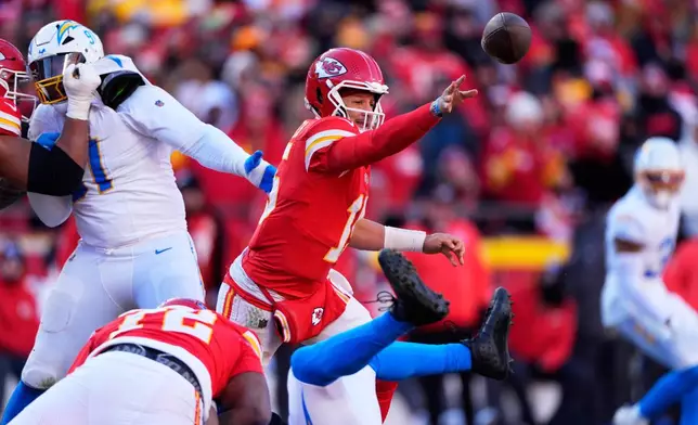 Kansas City Chiefs quarterback Patrick Mahomes (15) gets rid of the ball during the second half of an NFL football game against the Los Angeles Chargers Sunday, Dec. 14, 2025, in Kansas City, Mo. (AP Photo/Charlie Riedel)