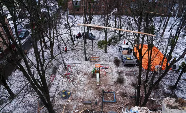 A yard is seen from the the roof of apartment building damaged after a Russian strike on Kyiv, Ukraine, on Saturday, Dec. 27, 2025. (AP Photo/Evgeniy Maloletka)