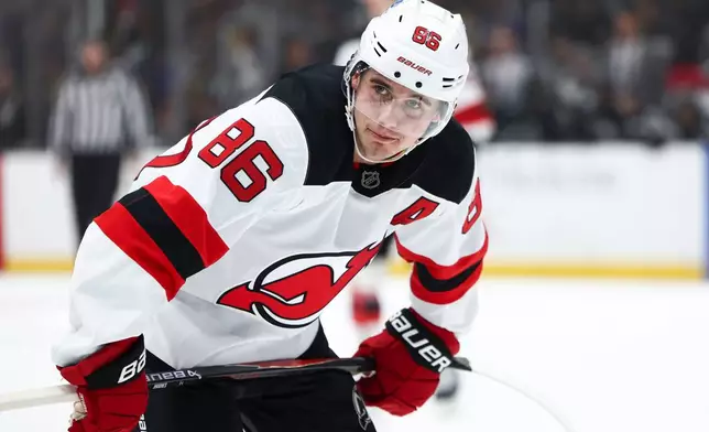 FILE - New Jersey Devils center Jack Hughes looks on during the first period of an NHL hockey game against the Los Angeles Kings, Nov. 1, 2025, in Los Angeles. (AP Photo/Jessie Alcheh, File)