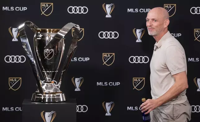 Vancouver Whitecaps head coach Jesper Sorensen walks past the MLS cup trophy as he leaves after a news conference Thursday, Dec. 4, 2025, in Fort Lauderdale, Fla., ahead of Saturday's of the MLS Cup soccer match against Inter Miami. (Darryl Dyck/The Canadian Press via