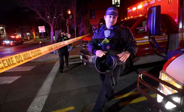 Emergency personnel gather on Waterman Street at Brown University in Providence, R.I., on Saturday, Dec. 13, 2025, during the investigation of a shooting. (AP Photo/Mark Stockwell)