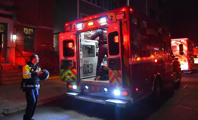 Emergency personnel step out of a vehicle near Brown University in Providence, R.I., on Saturday, Dec. 13, 2025, during the investigation of a shooting. (AP Photo/Steven Senne)