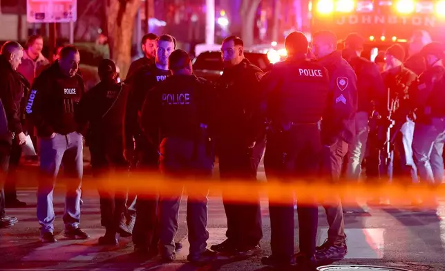 Police gather on Waterman Street in Providence, R.I., on Saturday, Dec. 13, 2025, during the investigation of a shooting. (AP Photo/Mark Stockwell)