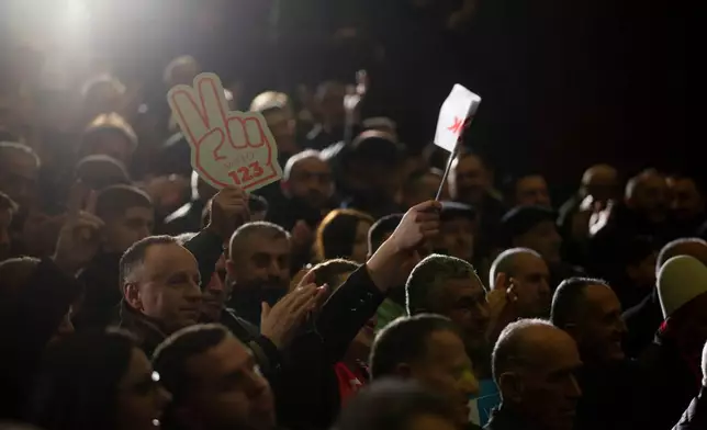Supporters of LDK (Democratic League of Kosovo) hold a victory sign poster during election rally in the town of Shtimje on Thursday, Dec. 25, 2025. (AP Photo/Visar Kryeziu)
