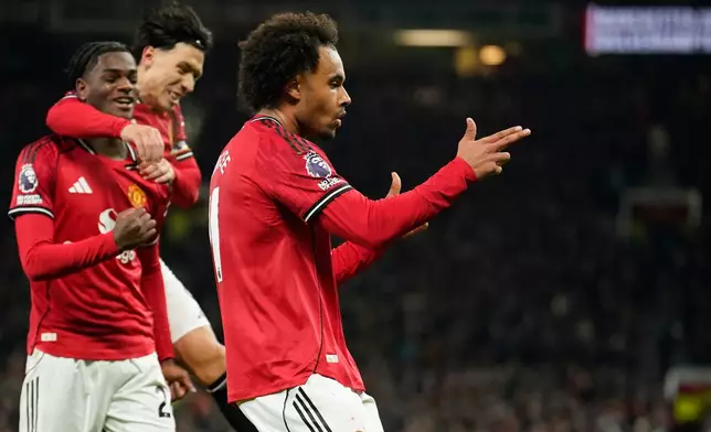 Manchester United's Joshua Zirkzee celebrates after he scored the opening goal during the English Premier League soccer match between Manchester United and Wolverhampton Wanderers in Manchester, England, Tuesday, Dec. 30, 2025. (AP Photo/Dave Thompson)