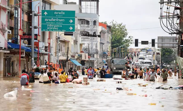 FILE - People wade through floodwaters in Songkhla province, southern Thailand, on Nov. 27, 2025. (AP Photo/Sarot Meksophawannakul, File)
