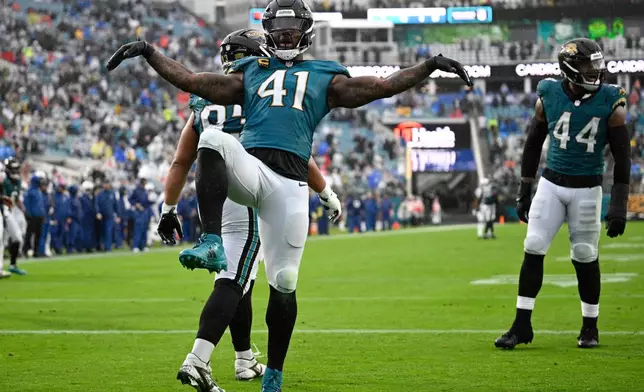 Jacksonville Jaguars defensive end Josh Hines-Allen (41) celebrates after getting a safety against the Indianapolis Colts during the second half of an NFL football game, Sunday, Dec. 7, 2025, in Jacksonville, Fla. (AP Photo/Phelan M. Ebenhack)