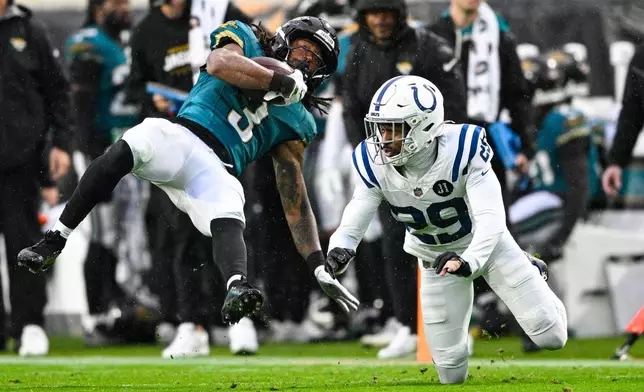 Jacksonville Jaguars wide receiver Jakobi Meyers (3) makes a catch over Indianapolis Colts cornerback Mekhi Blackmon (29) during the second half of an NFL football game, Sunday, Dec. 7, 2025, in Jacksonville, Fla. (AP Photo/Phelan M. Ebenhack)