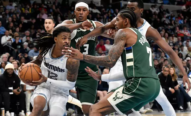 Memphis Grizzlies guard Ja Morant (12) drives against Milwaukee Bucks guard Kevin Porter Jr. (7) as Bucks center Myles Turner (3) and Grizzlies center Christian Koloko, back right, move for position in the first half of an NBA basketball game Friday, Dec. 26, 2025, in Memphis, Tenn. (AP Photo/Brandon Dill)