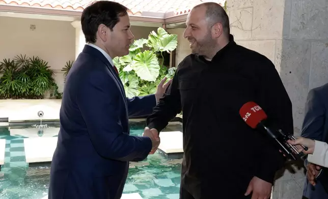 FILE - Secretary of State Marco Rubio, left, and Secretary of the National Security of Ukraine Rustem Umerov shake hands, Nov. 30, 2025, in Hallandale Beach, Fla. (AP Photo/Terry Renna, File)