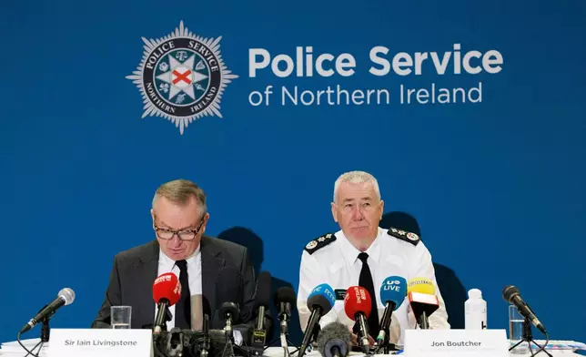 Kenova chief Iain Livingstone, left, and Police Service of Northern Ireland (PSNI) Chief Constable Jon Boutcher speak to the media at the Stormont Hotel, in Belfast, Tuesday, Dec. 9, 2025, following the publication of the final Kenova report. (Liam McBurney/PA via AP)