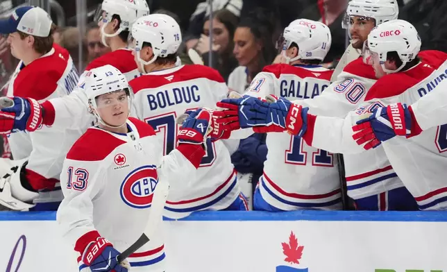 Montréal Canadiens right wing Cole Caufield (13) celebrates after his goal against the Toronto Maple Leafs with teammates on the bench during second-period NHL hockey game action in Toronto, Saturday, Dec. 6, 2025. (Frank Gunn/The Canadian Press via AP