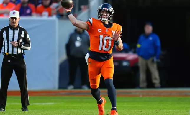 Denver Broncos quarterback Bo Nix (10) looks to throw a pass against the Jacksonville Jaguars during the first half of an NFL football game in Denver, Sunday, Dec. 21, 2025. (AP Photo/Jack Dempsey)