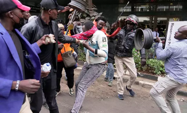 A suspected pro-government supporter is attacked by protesters during a demonstration over the death of blogger Albert Ojwang in police custody, in downtown Nairobi, Kenya, June 17, 2025. (AP Photo/Brian Inganga, File)