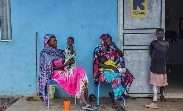 Patients sit outside the malnutrition ward of Bunj Hospital in Maban, South Sudan, Aug. 19, 2025. (AP Photo/Caitlin Kelly, File)