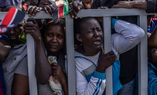 People react during the viewing of the body of former Kenyan Prime Minister Raila Odinga at Jomo Kenyatta Stadium in Kisumu, Kenya, Oct. 18, 2025. (AP Photo/Samson Otieno, File)