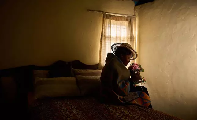 Lisebo Lechela, 53, an HIV-positive sex worker, poses for a portrait in her house in Maputsoe, Lesotho, July 17, 2025. (AP Photo/Bram Janssen, File)