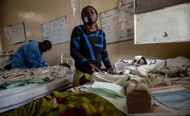 Mariam Nasibu stands by her 10-year-old daughter Deborah, who was wounded in the fighting between M23 rebels and Congolese armed forces, in Goma, Democratic Republic of the Congo, Jan. 23, 2025. (AP Photo/Moses Sawasawa, File)