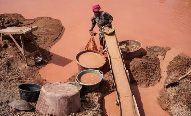 A woman processes gold at a mining site in the Kedougou region of Senegal, Jan. 16, 2025. (AP Photo/Annika Hammerschlag, File)