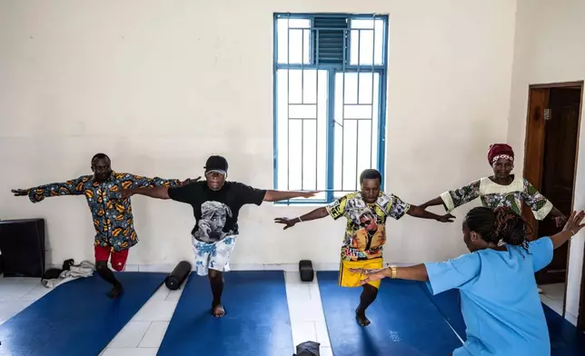 Physiotherapist Gisèle Kantu, bottom right, works with amputees wounded by fighting in the region, at an orthopedic center run by the Catholic church and supported by the Red Cross in Goma, eastern Congo, Aug. 29, 2025. (AP Photo/Moses Sawasawa, File)