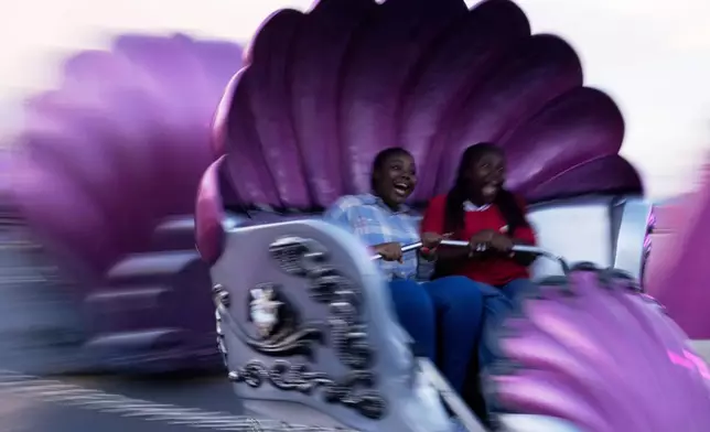 Girls ride the Tempest at the Rand Easter Show in Johannesburg, South Africa, April 19, 2025. (AP Photo/Themba Hadebe, File)