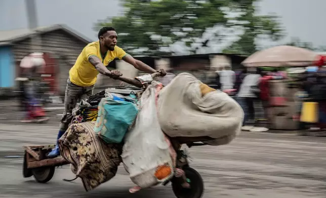 A person displaced by the fighting with M23 rebels evacuates with their belongings to downtown Goma, Democratic Republic of the Congo, Jan. 26, 2025. (AP Photo/Moses Sawasawa, File)